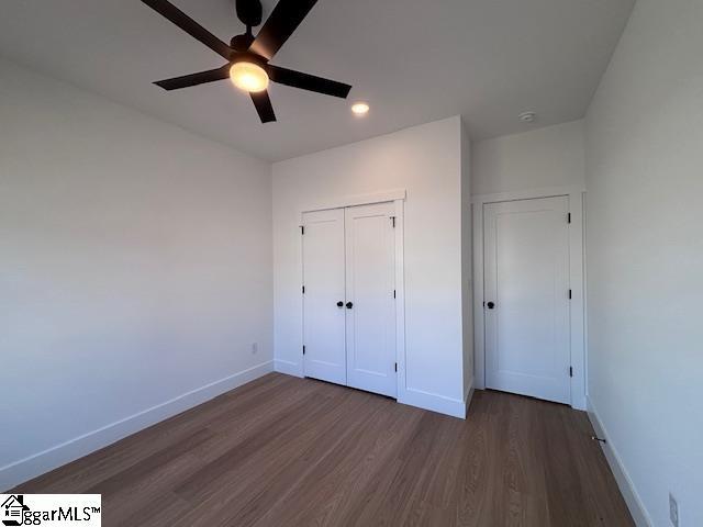 550 Vault Way, Roebuck, SC 29376 - unfurnished bedroom featuring ceiling fan, recessed lighting, baseboards, dark wood-type flooring, and a closet