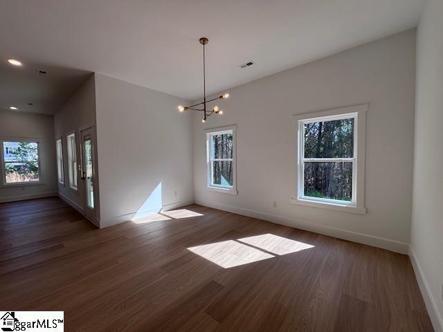 550 Vault Way, Roebuck, SC 29376 - unfurnished dining area featuring an inviting chandelier, plenty of natural light, wood finished floors, and visible vents