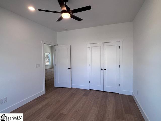 550 Vault Way, Roebuck, SC 29376 - unfurnished bedroom with baseboards, ceiling fan, and wood finished floors