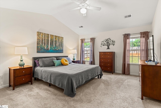 bedroom featuring vaulted ceiling, light colored carpet, and visible vents