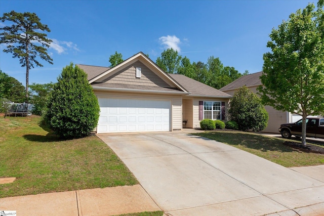 ranch-style home featuring an attached garage, concrete driveway, and a front yard