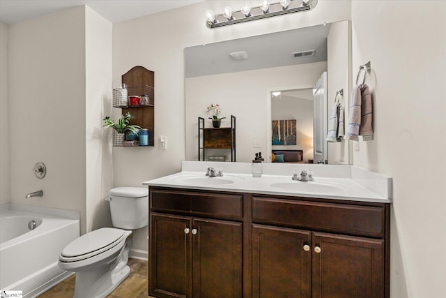 ensuite bathroom featuring a sink, toilet, double vanity, and visible vents