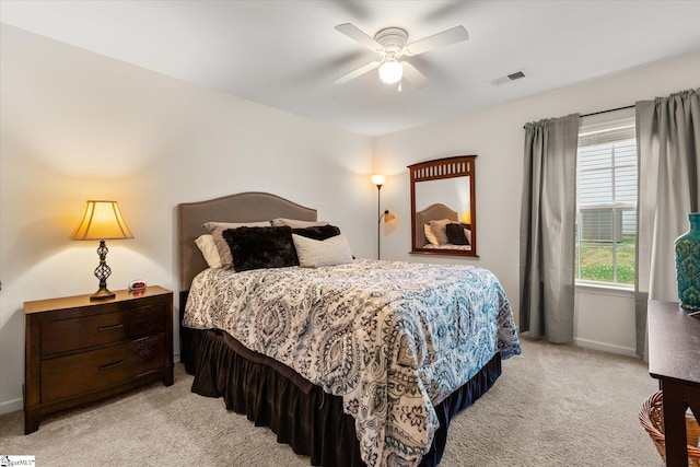 bedroom with visible vents, baseboards, ceiling fan, and light carpet