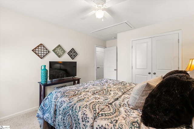 bedroom featuring ceiling fan, carpet, attic access, baseboards, and a closet