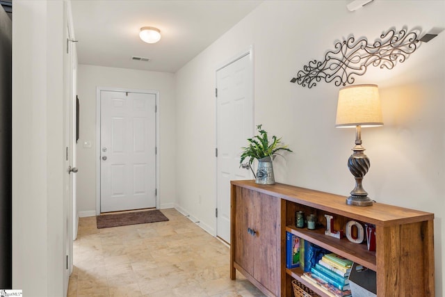 interior space with baseboards and visible vents