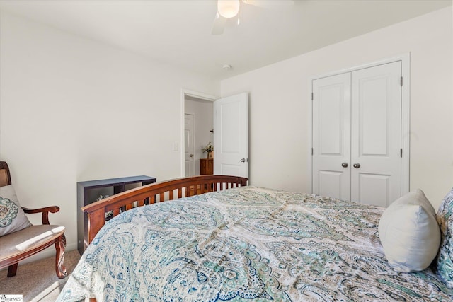 carpeted bedroom featuring a closet and a ceiling fan