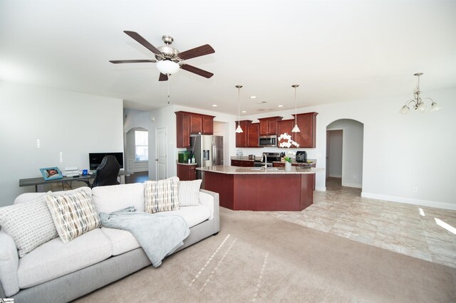 920 Ravenfield Dr, Duncan, SC 29334 - living room featuring arched walkways, baseboards, recessed lighting, and ceiling fan with notable chandelier