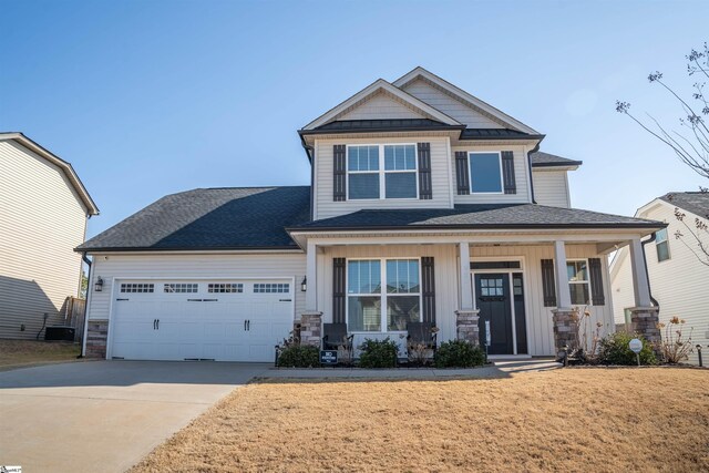 920 Ravenfield Dr, Duncan, SC 29334 - craftsman-style house featuring an attached garage, a front lawn, stone siding, a porch, and driveway