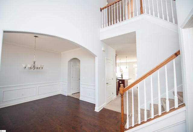 920 Ravenfield Dr, Duncan, SC 29334 - entrance foyer featuring ornamental molding, stairs, wood finished floors, a wainscoted wall, and a notable chandelier