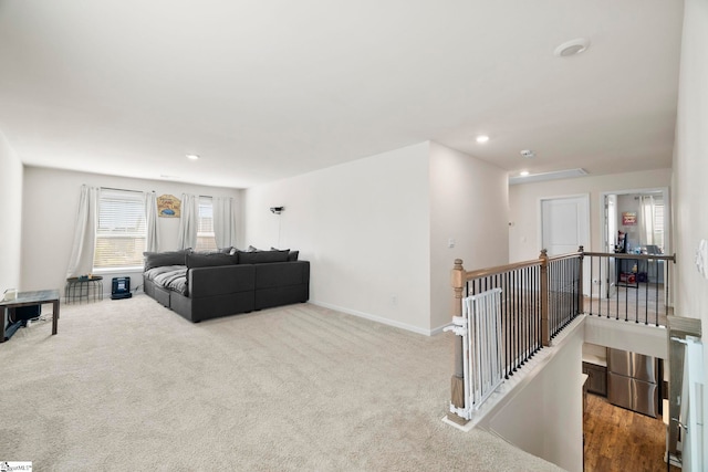 carpeted living room with recessed lighting and baseboards