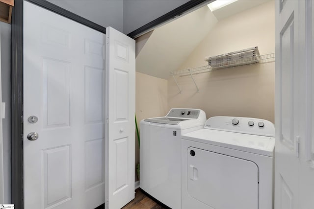 laundry area featuring laundry area, dark wood-style flooring, and washing machine and clothes dryer
