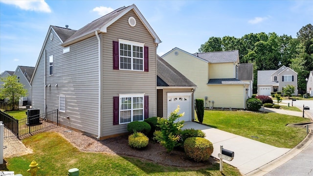 traditional-style home featuring fence, a front lawn, a garage, central AC unit, and concrete driveway