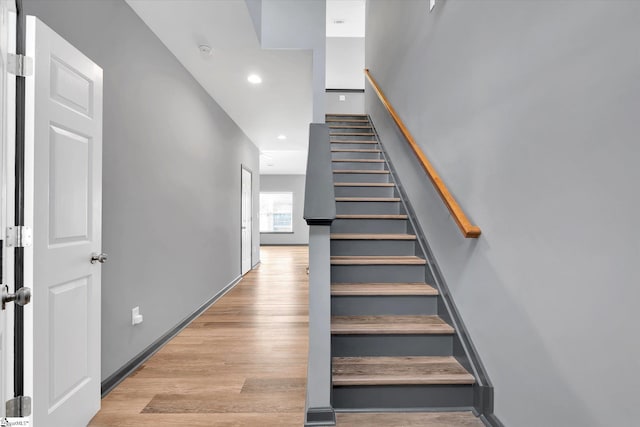 staircase featuring recessed lighting and wood finished floors