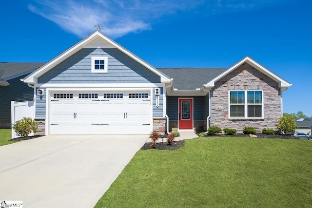 craftsman-style home featuring an attached garage, driveway, stone siding, and a front lawn