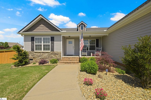 327 Terra Plains Dr, Greer, SC 29651 - view of front of property with a porch, fence, stone siding, and a front yard