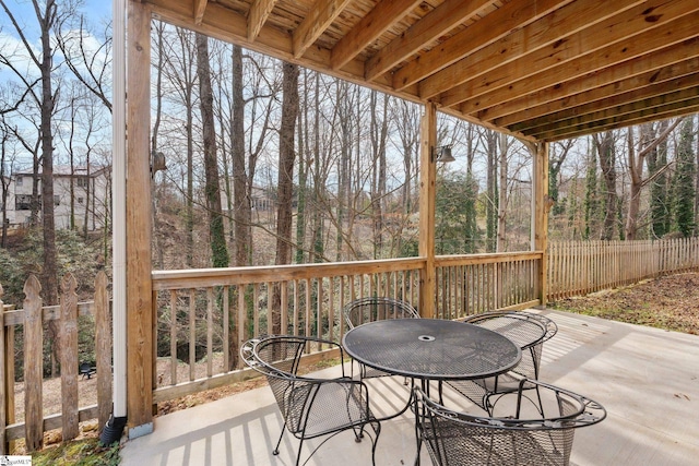 exterior space with fence, outdoor dining space, and a patio