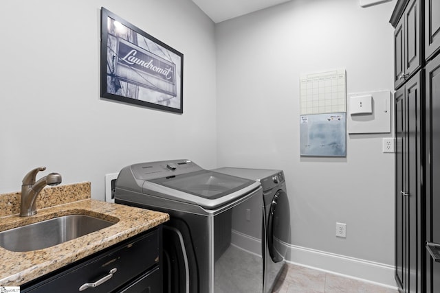 155 Tyger Farm Ln, Woodruff, SC 29388 - clothes washing area featuring washing machine and dryer, cabinet space, a sink, baseboards, and light tile patterned flooring