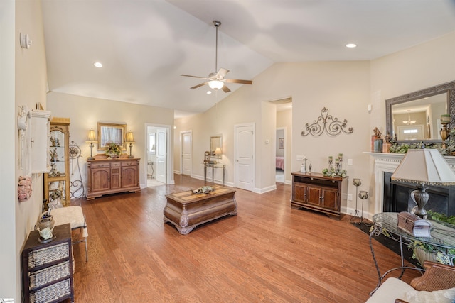 127 Alberta Cir, Piedmont, SC 29673 - living room featuring wood finished floors, baseboards, ceiling fan, a fireplace with flush hearth, and vaulted ceiling