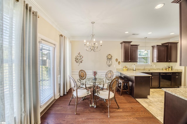 127 Alberta Cir, Piedmont, SC 29673 - dining space featuring an inviting chandelier, ornamental molding, light wood finished floors, and wainscoting