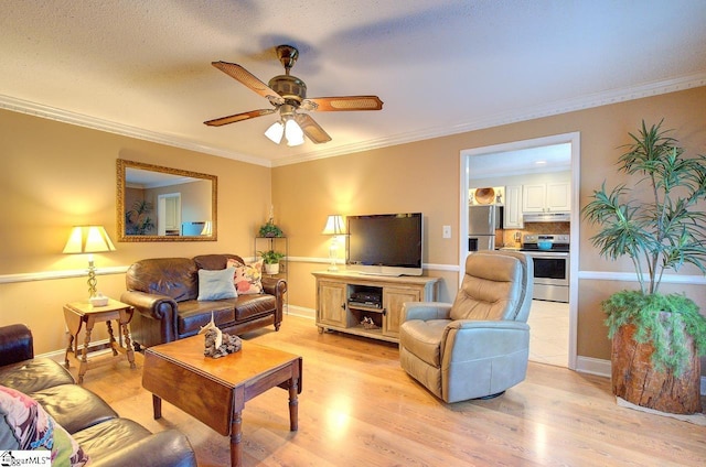 living area with crown molding, light wood finished floors, ceiling fan, and baseboards