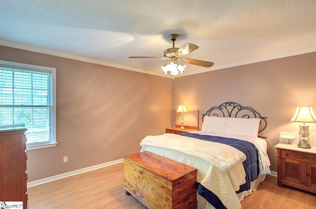 bedroom featuring light wood-style floors, baseboards, ornamental molding, and a textured ceiling