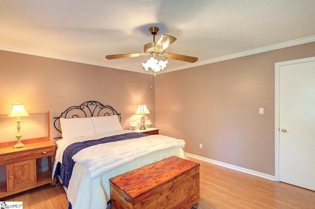 bedroom with crown molding, a ceiling fan, baseboards, and light wood-style flooring