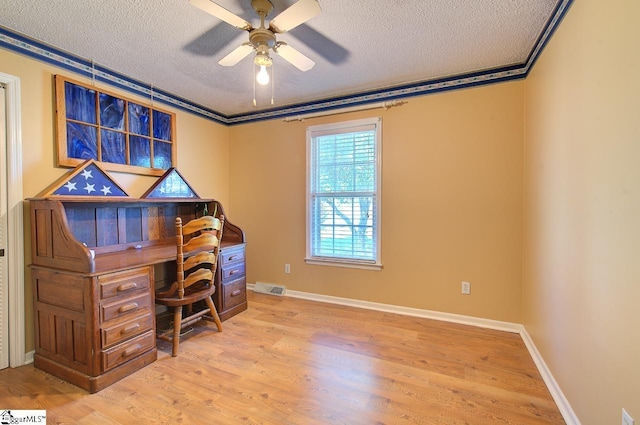 office space with light wood-style floors, ceiling fan, a textured ceiling, and visible vents