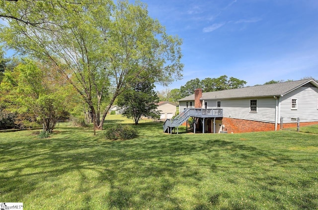 view of yard with stairs and a deck