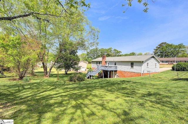 view of yard with a wooden deck and stairs