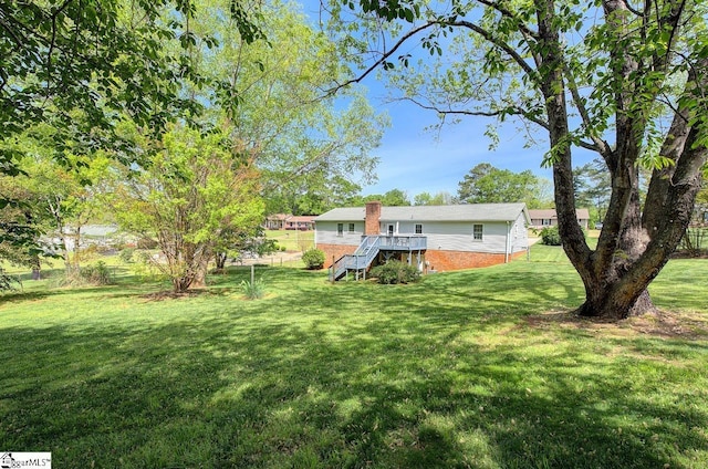 view of yard with stairs and a deck