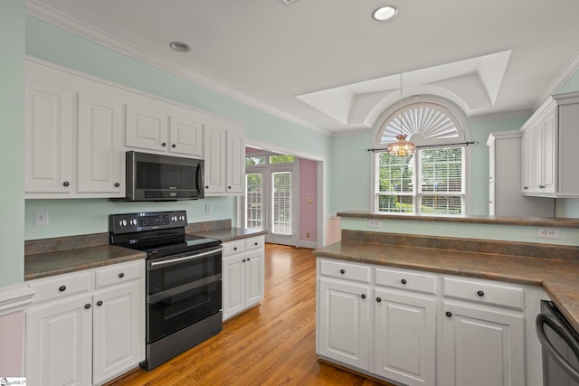 kitchen with crown molding, white cabinetry, dark countertops, and appliances with stainless steel finishes