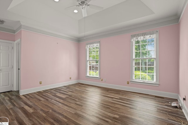 empty room featuring baseboards, ornamental molding, a ceiling fan, and wood finished floors