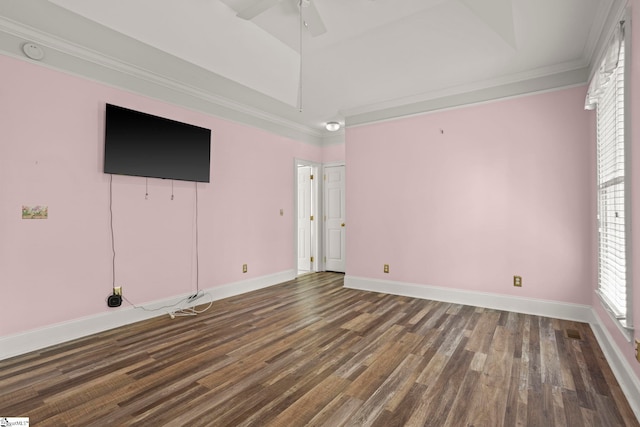 interior space with baseboards, ornamental molding, a ceiling fan, and dark wood-type flooring