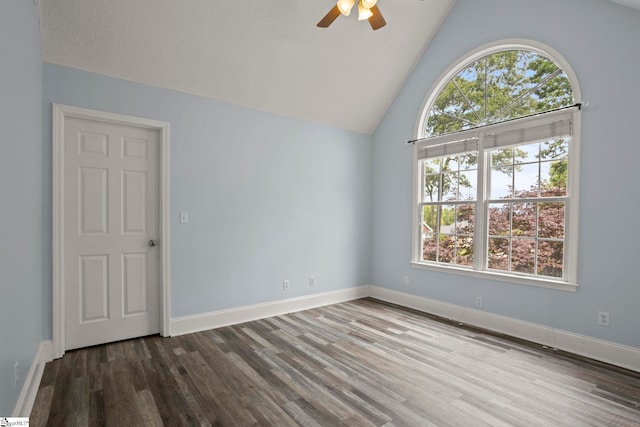 spare room with baseboards, ceiling fan, and wood finished floors