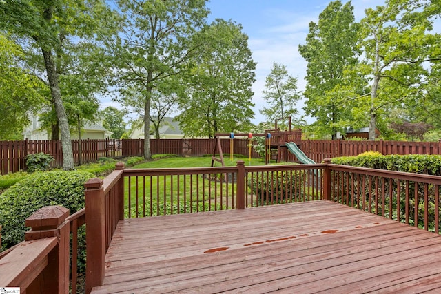 wooden terrace with a lawn, a fenced backyard, and a playground