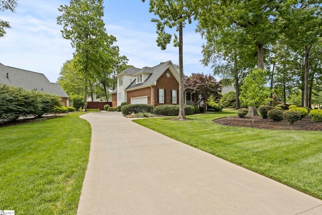 view of home's community featuring a garage, a yard, and driveway