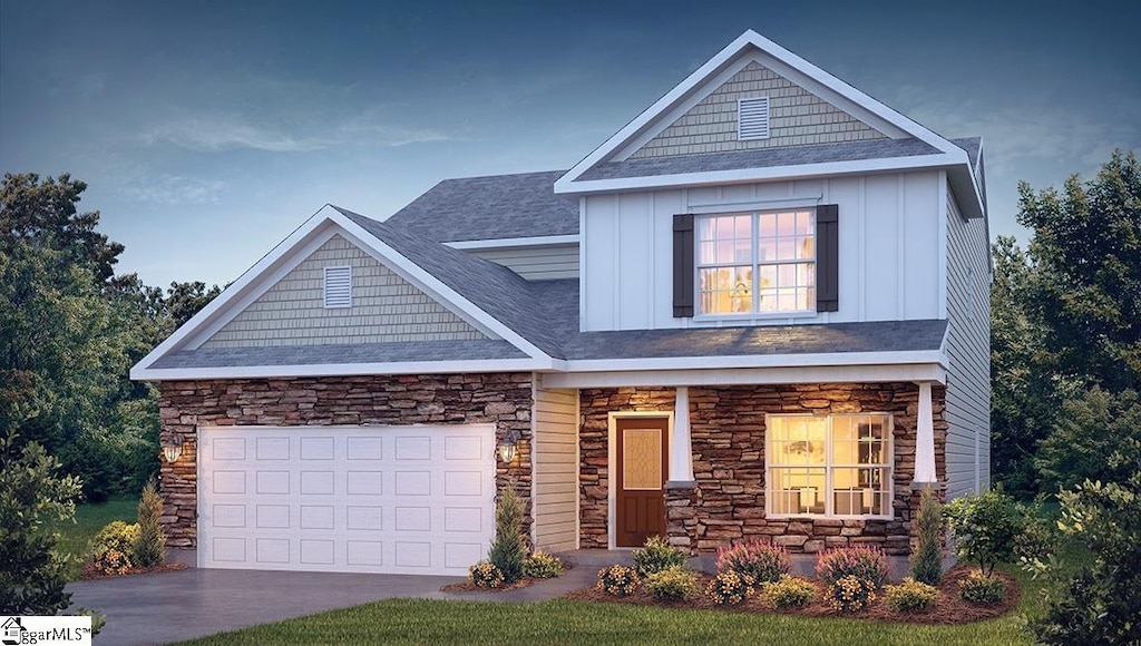 craftsman-style home with board and batten siding, concrete driveway, stone siding, and a garage
