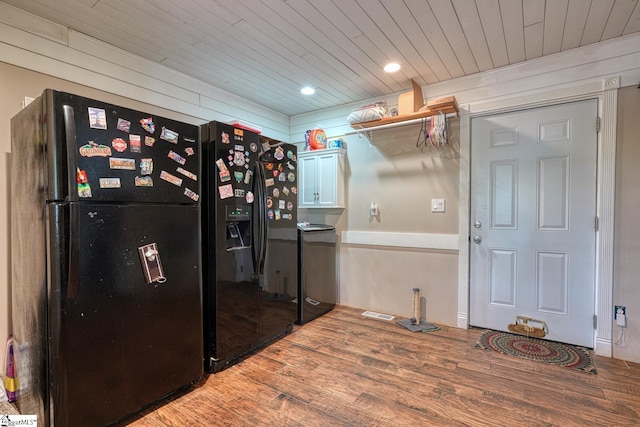 kitchen featuring freestanding refrigerator, recessed lighting, wooden ceiling, wood finished floors, and black fridge with ice dispenser