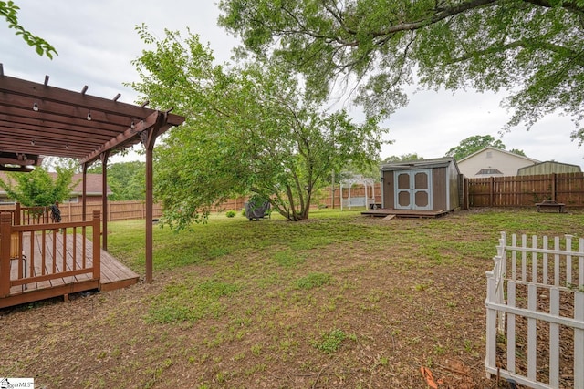 view of yard with a fenced backyard, a storage unit, an outdoor structure, and a pergola