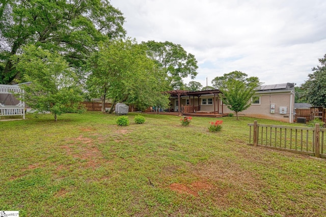 view of yard with fence and a wooden deck