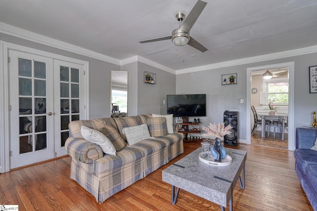 living area featuring a ceiling fan, french doors, and wood finished floors