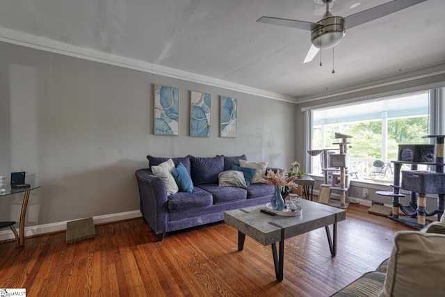 living room with crown molding, baseboards, a ceiling fan, and wood finished floors