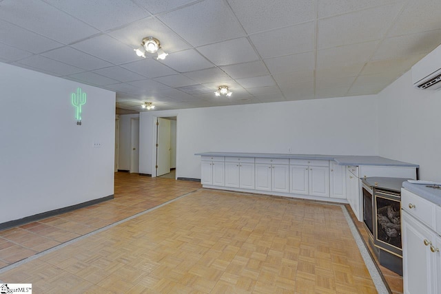 118 Pine Ln, Simpsonville, SC 29681 - interior space with baseboards, a wall unit AC, and a drop ceiling