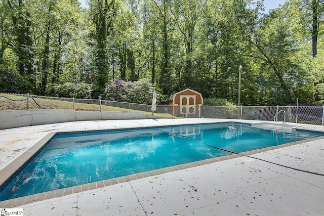 118 Pine Ln, Simpsonville, SC 29681 - view of swimming pool featuring a fenced in pool, an outdoor structure, fence, and a storage shed