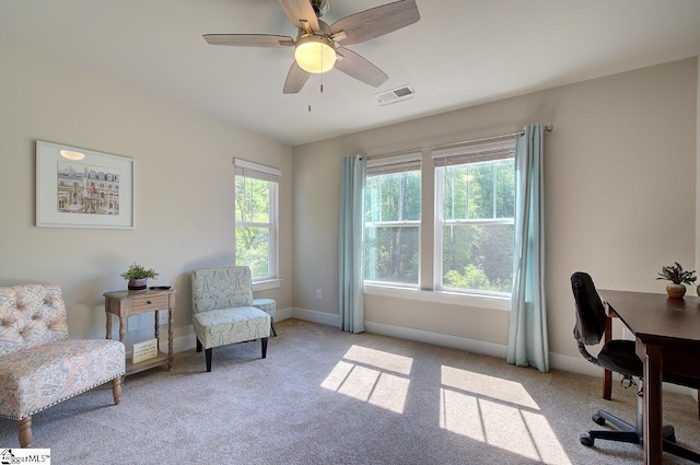 sitting room featuring carpet floors, baseboards, a ceiling fan, and visible vents