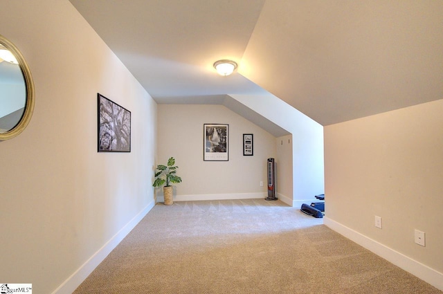 bonus room featuring baseboards, vaulted ceiling, and carpet