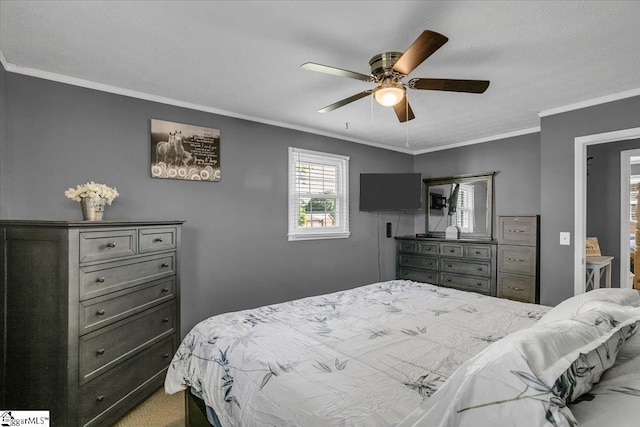 carpeted bedroom featuring ornamental molding and a ceiling fan