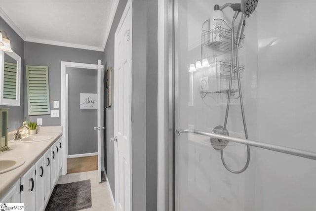 bathroom with double vanity, ornamental molding, baseboards, an enclosed shower, and a sink
