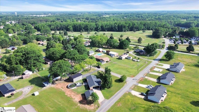 drone / aerial view featuring a view of trees and a residential view
