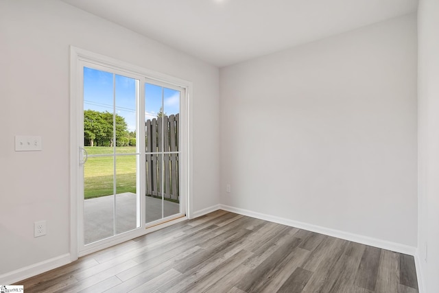 empty room featuring baseboards and wood finished floors